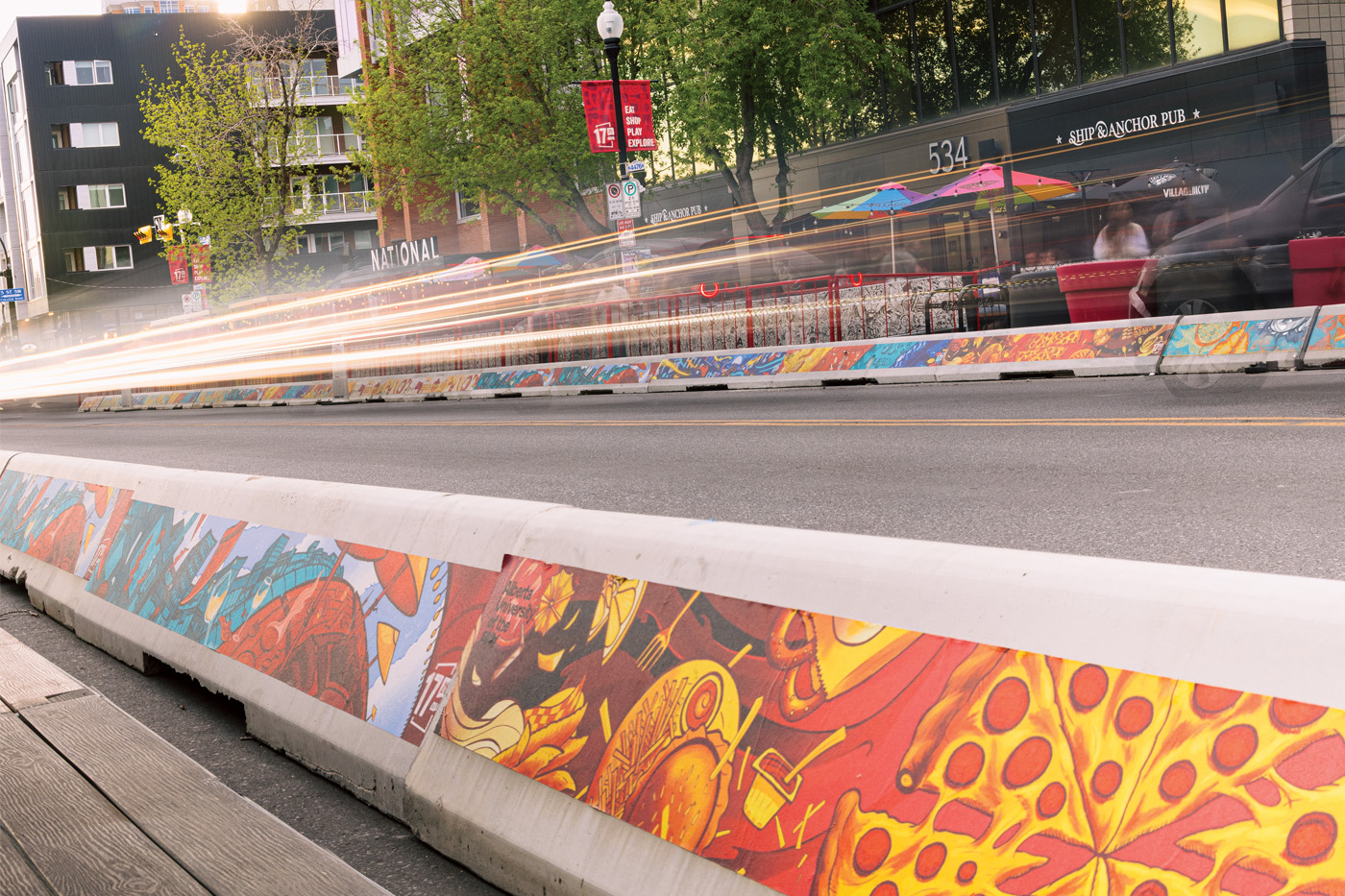 A car speeds by on a colourful street in the downtown Beltline neighbourhood.