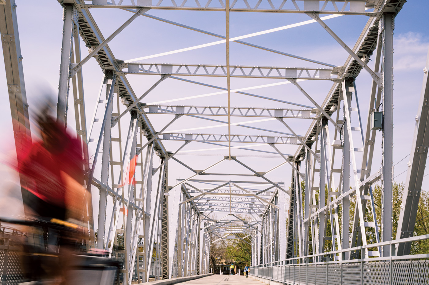 A cyclist speeds past on a bridge in Bowness.