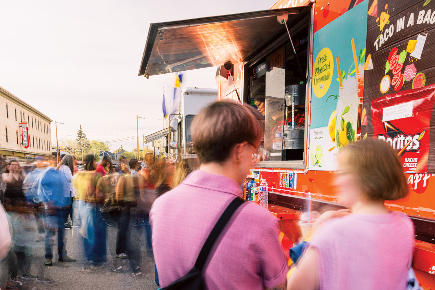 Two people stand outside a food truck in the Inglewood neighbourhood.