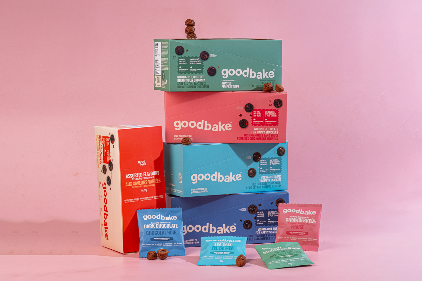Colourful snack boxes that are stacked on top of each other with small snack packages displayed in front of them.